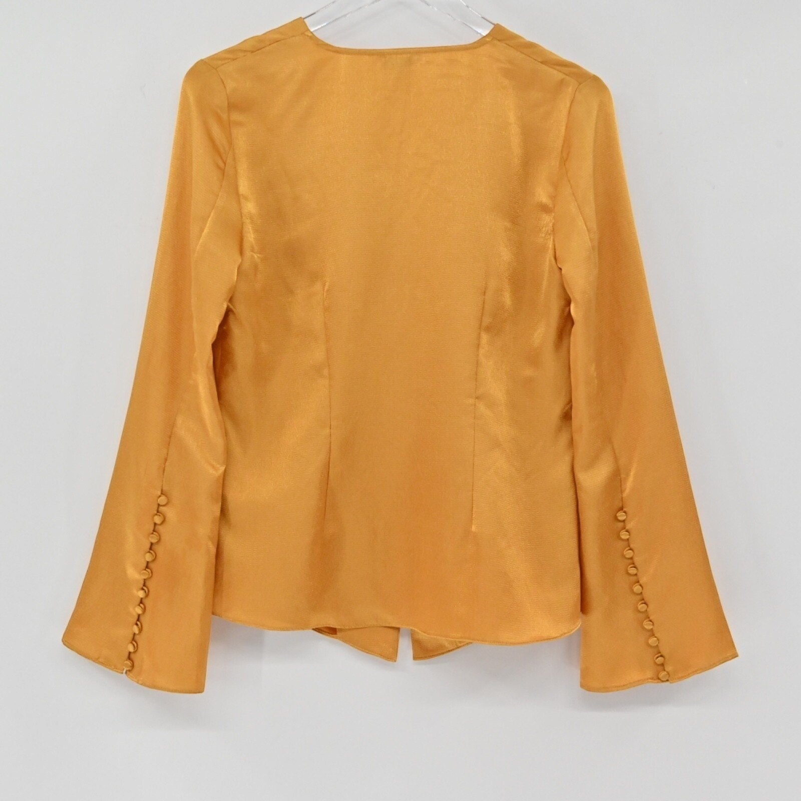 Lynn's Closet Boutique golden-mustard silky bell sleeve top with button cuff details, back view.