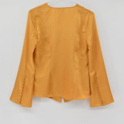 Lynn's Closet Boutique golden-mustard silky bell sleeve top with button cuff details, back view.