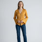 Model wearing a mustard yellow Joie Madora bell sleeve top with button-front detail from Lynn's Closet Boutique