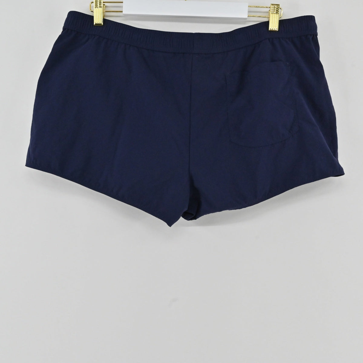 Lynn's Closet Boutique Lilly Pulitzer navy blue Luxletic athletic shorts with a back pocket hanging on a hanger