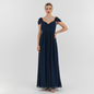 Model wearing a Lynn's Closet Boutique navy blue Lulus floor-length gown with ruched bodice and flutter sleeves.
