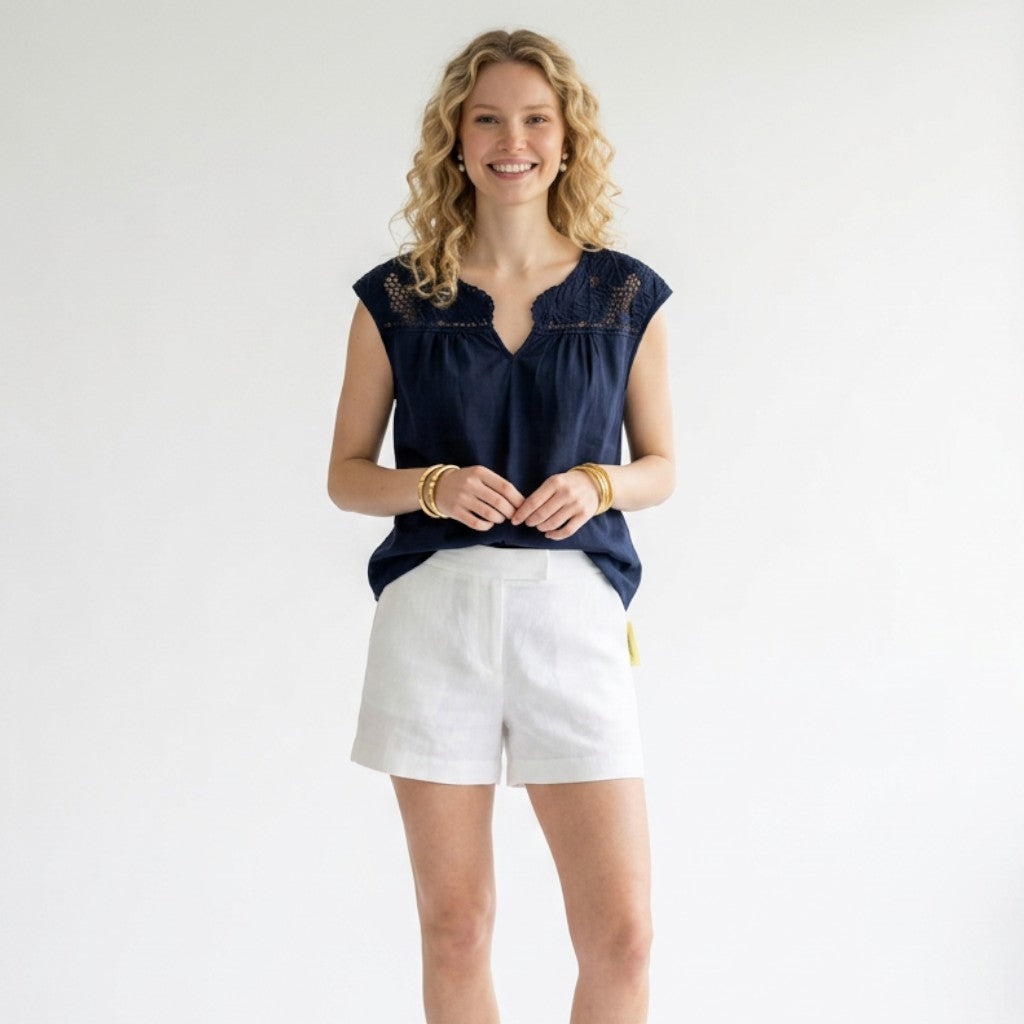Model wearing a navy Lilly Pulitzer crochet top with white shorts, styled by Lynn's Closet Boutique.