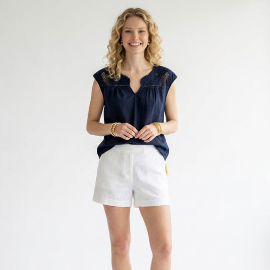 Model wearing a navy Lilly Pulitzer crochet top with white shorts, styled by Lynn's Closet Boutique.