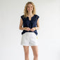 Model wearing a navy Lilly Pulitzer crochet top with white shorts, styled by Lynn's Closet Boutique.