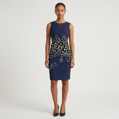 Model wearing a Lynn's Closet Boutique Carolina Herrera navy sheath dress with a black and white floral motif.