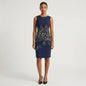 Model wearing a Lynn's Closet Boutique Carolina Herrera navy sheath dress with a black and white floral motif.