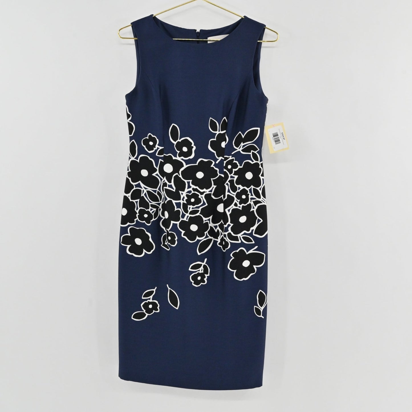 Lynn's Closet Boutique Carolina Herrera navy blue sheath dress with black and white floral print on a gold hanger