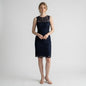 Model wearing a navy blue Adrianna Papell lace sheath dress with a sleeveless design from Lynn's Closet Boutique