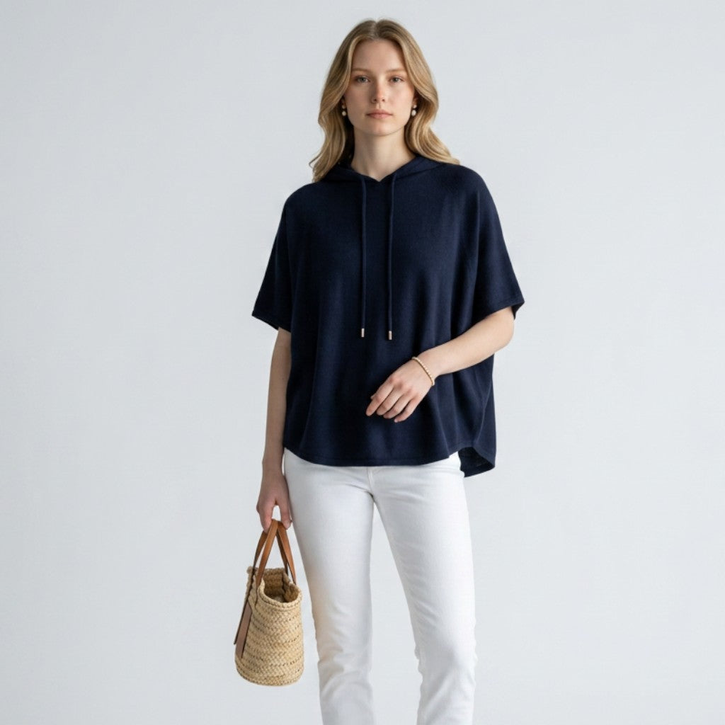 Lynn's Closet Boutique Joie navy blue merino wool short-sleeve hoodie worn by a model with white jeans and sandals