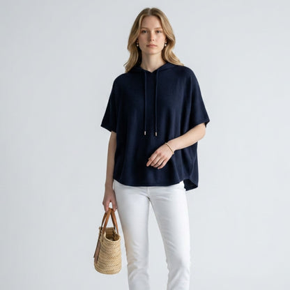 Lynn's Closet Boutique Joie navy blue merino wool short-sleeve hoodie worn by a model with white jeans and sandals