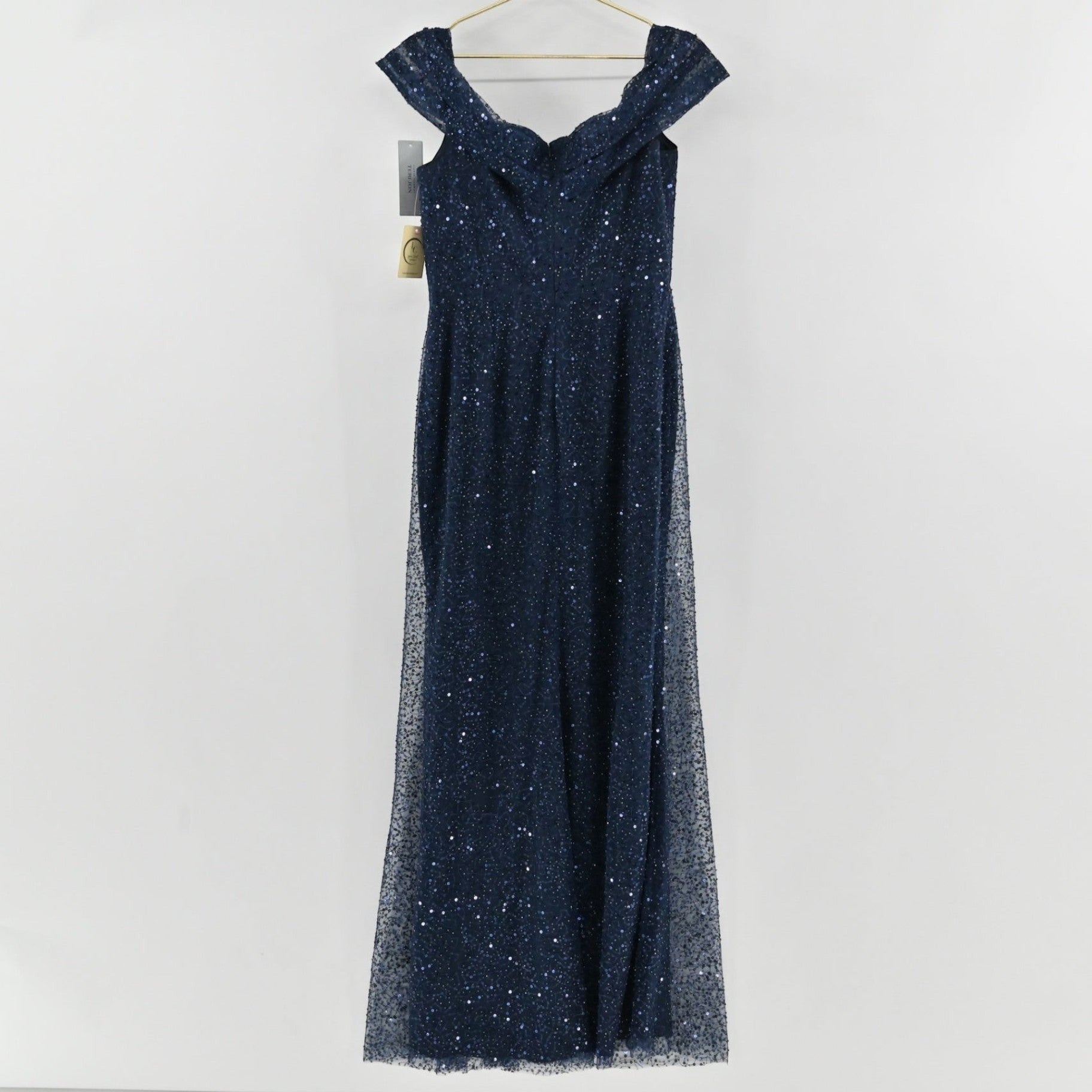 Lynn's Closet Boutique navy sequin floor-length gown with an off-the-shoulder neckline on a hanger.