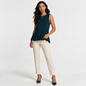 Model wearing a Lynn's Closet Boutique navy blue silk sleeveless peplum top with cream trousers and heels.