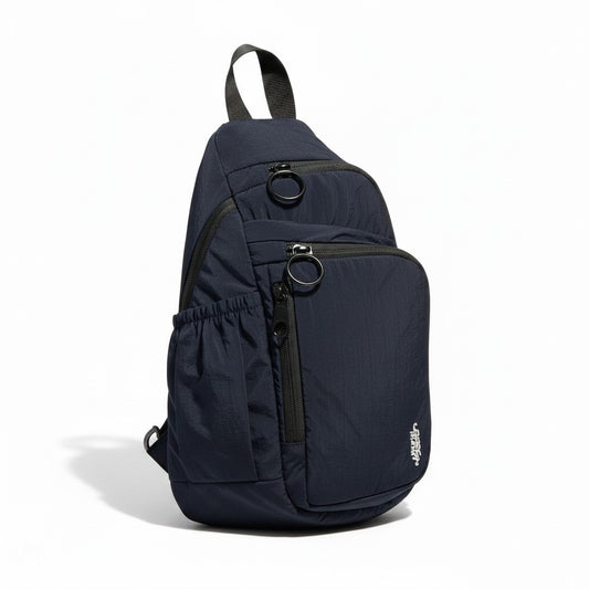 Lynn's Closet Boutique Free People navy sling bag with multiple zippered pockets and a side elasticated pouch.
