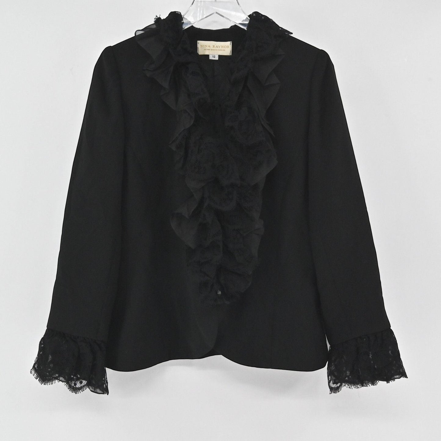 Lynn's Closet Boutique Nina Raynor black blazer featuring a ruffled lace front placket and lace-trimmed cuffs.