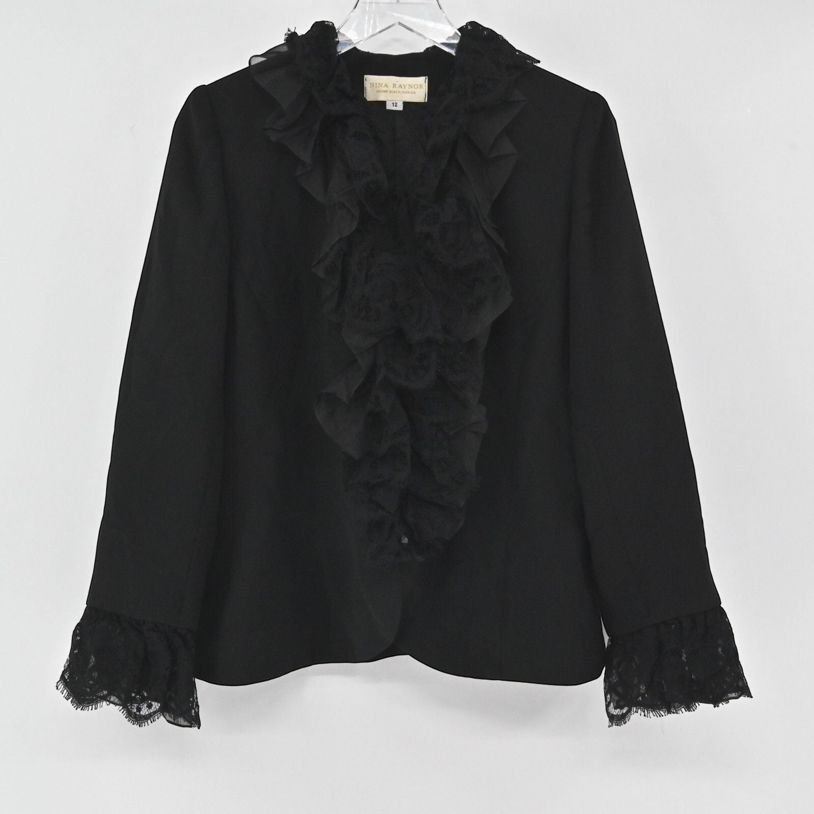 Lynn's Closet Boutique Nina Raynor black blazer featuring a ruffled lace front placket and lace-trimmed cuffs.