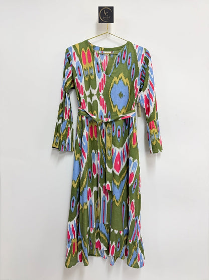 Lynn's Closet Boutique olive green midi dress with a vibrant multi-colored ikat print, V-neck, and bell sleeves.