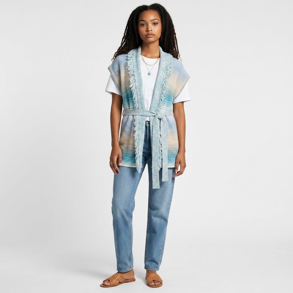 Model wearing a Lynn's Closet Boutique blue and beige ombre belted cardigan with fringe trim over a white t-shirt.
