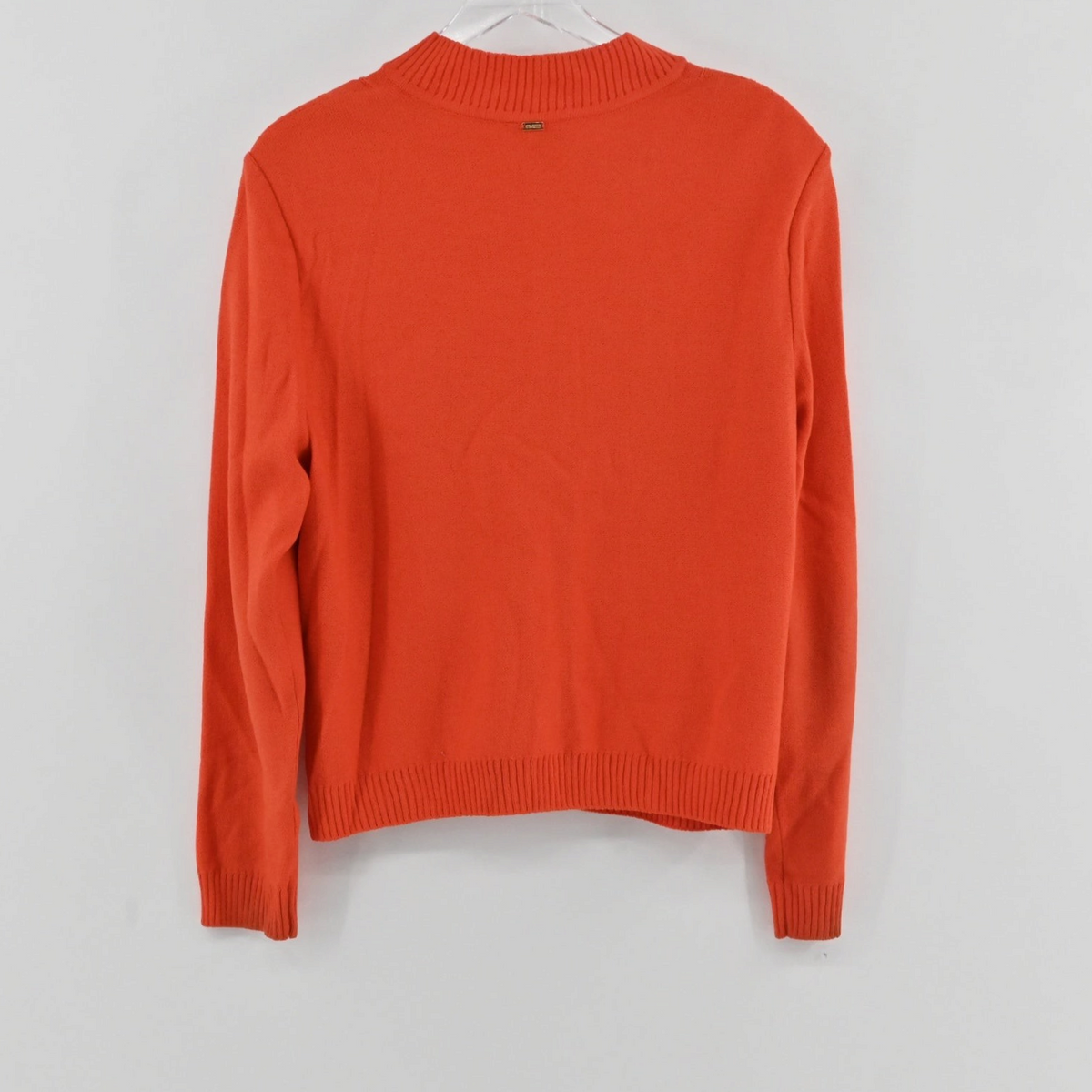 Lynn's Closet Boutique St. John Sport orange mock neck zip-up sweater, back view showing ribbed hem and cuffs.