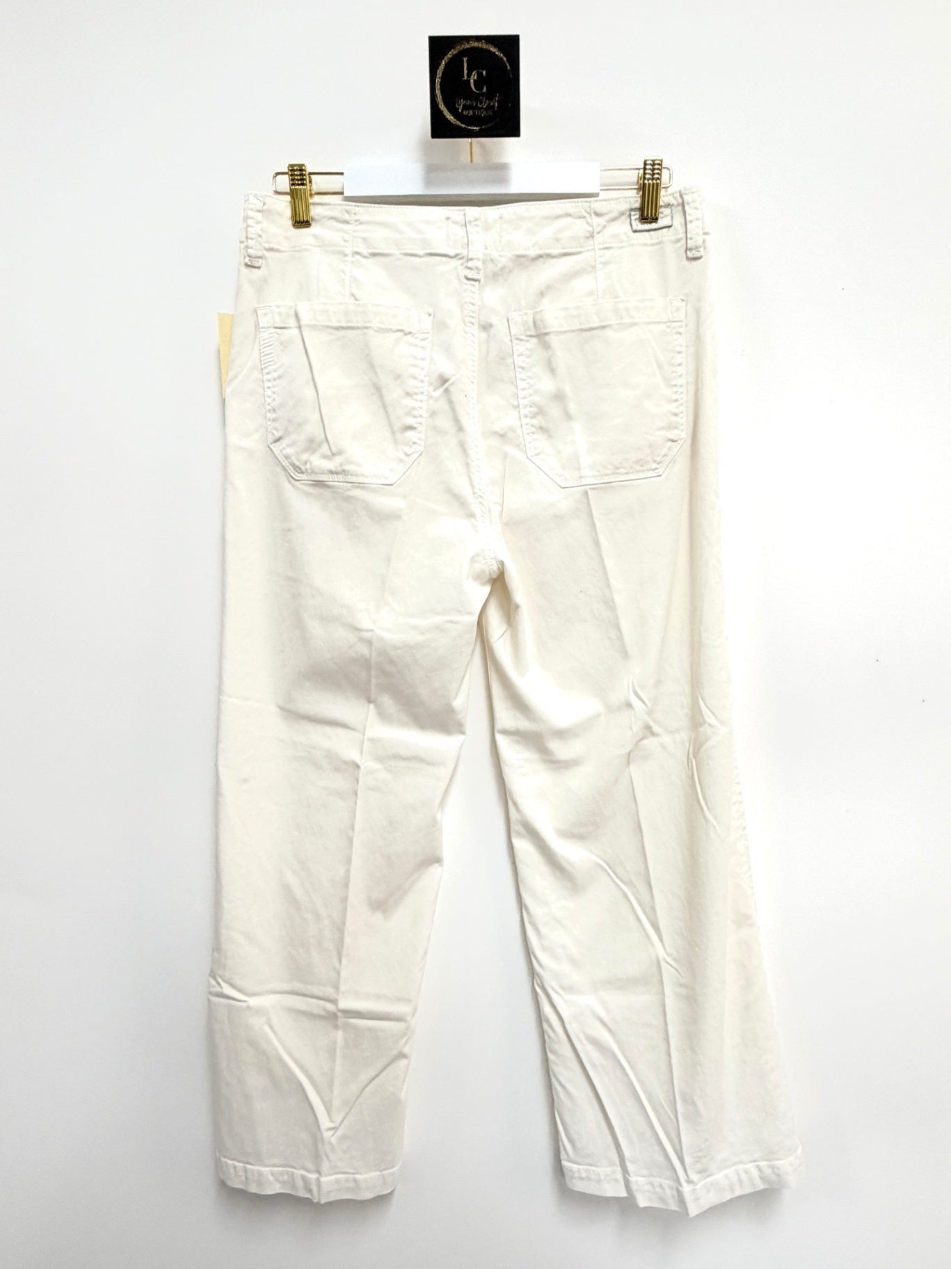 Lynn's Closet Boutique Paige white wide-leg pants featuring back pockets and a relaxed fit, shown from the back.