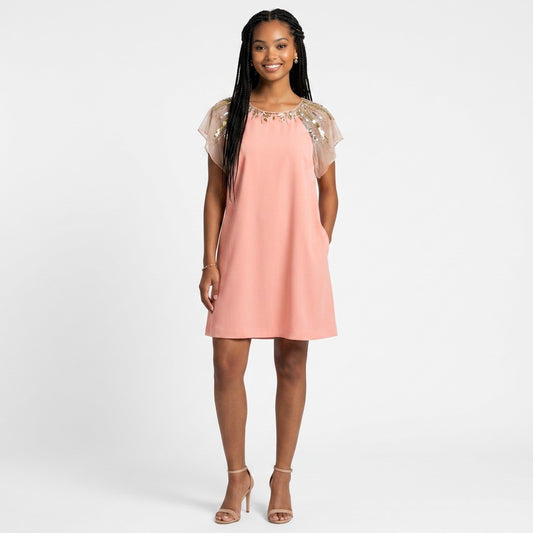 Model wearing a Lynn's Closet Boutique Aidan Mattox pink flutter sleeve dress with gold beaded shoulder detail