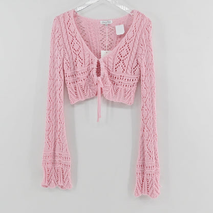 Lynn's Closet Boutique Emory Park pastel pink cropped crochet cardigan with long flared sleeves and front tie closure.