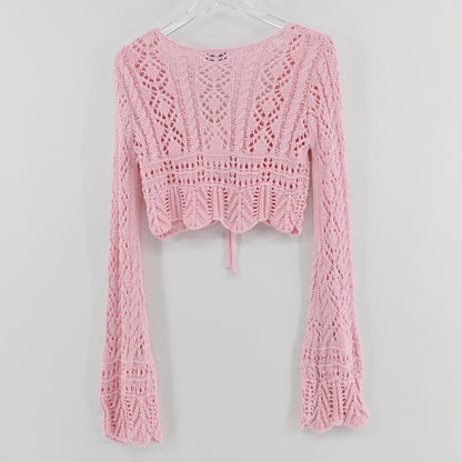 Lynn's Closet Boutique Emory Park pastel pink cropped crochet cardigan with long flared sleeves and front tie closure.