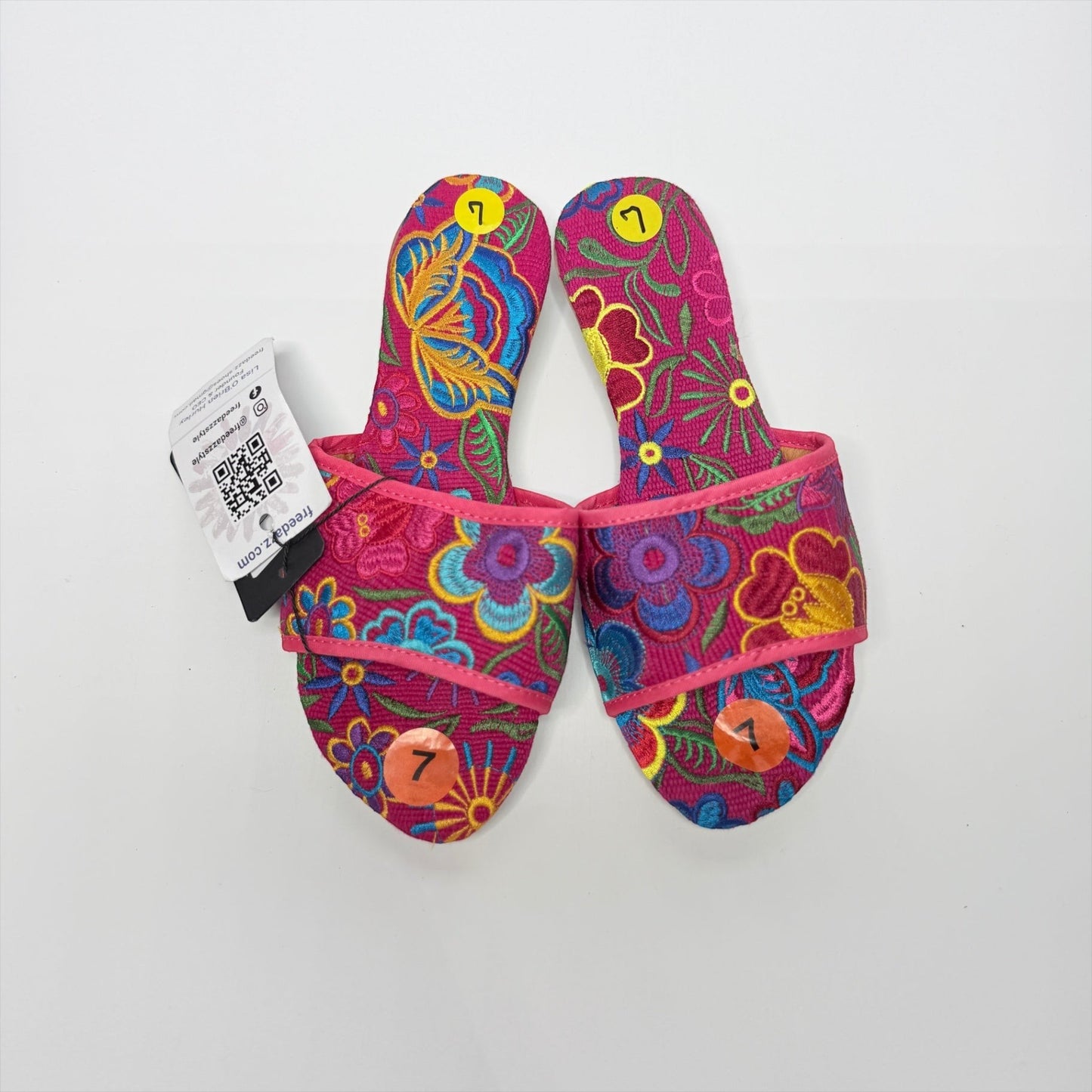 Lynn's Closet Boutique FreeDazz pink slides with vibrant multi-colored floral embroidery and size 7 stickers attached.