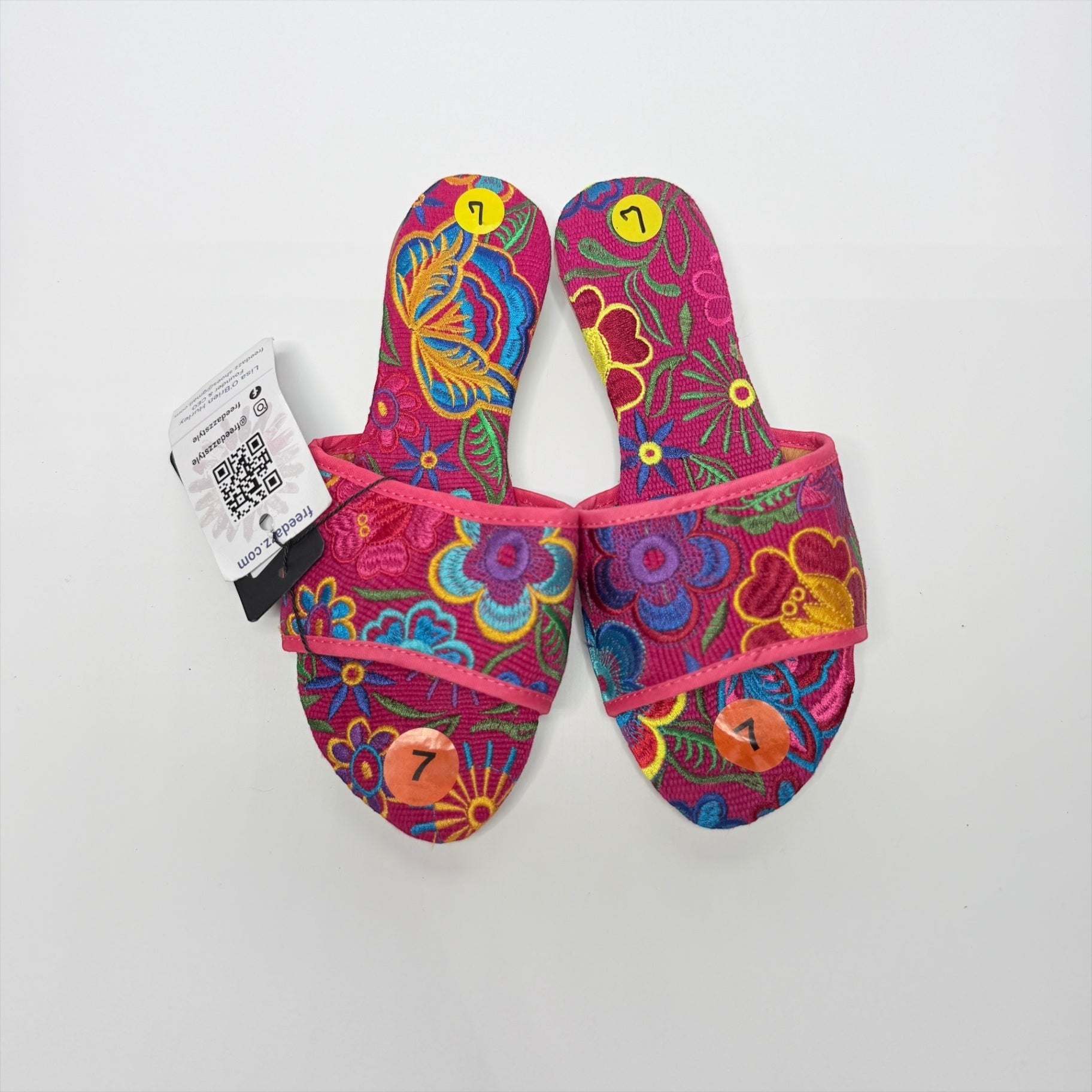 Lynn's Closet Boutique FreeDazz pink slides with vibrant multi-colored floral embroidery and size 7 stickers attached.