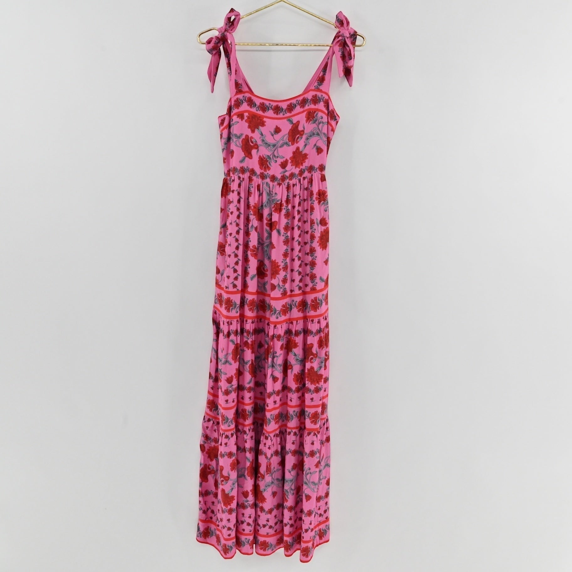 Lynn's Closet Boutique Beach Riot pink floral maxi dress with square neckline, tie straps, and tiered skirt.