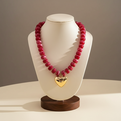Lynn's Closet Boutique chunky pink acrylic bead necklace with a polished gold-tone heart pendant on a display bust.