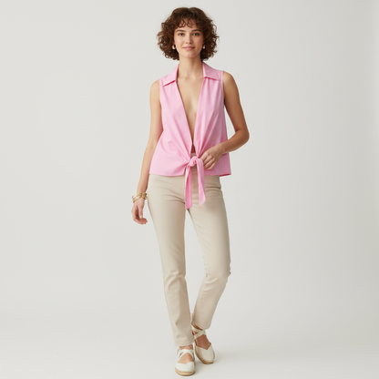 Model wearing a Lynn's Closet Boutique vintage pink sleeveless wrap top with a collar and tie-front detail.