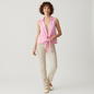Model wearing a Lynn's Closet Boutique vintage pink sleeveless wrap top with a collar and tie-front detail.