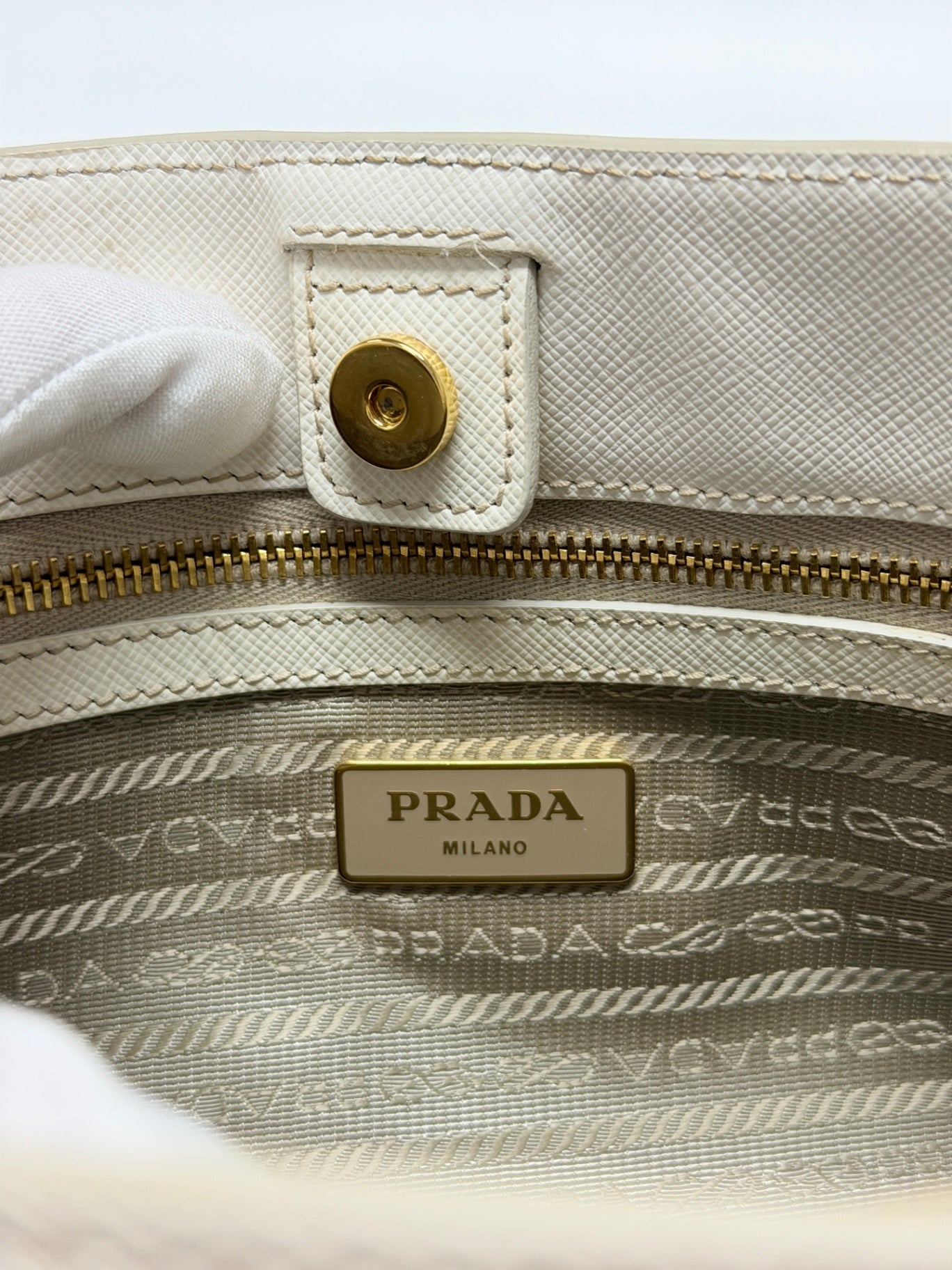 Lynn's Closet Boutique Prada Galleria handbag interior featuring gold logo plaque, zipper, and branded fabric lining.