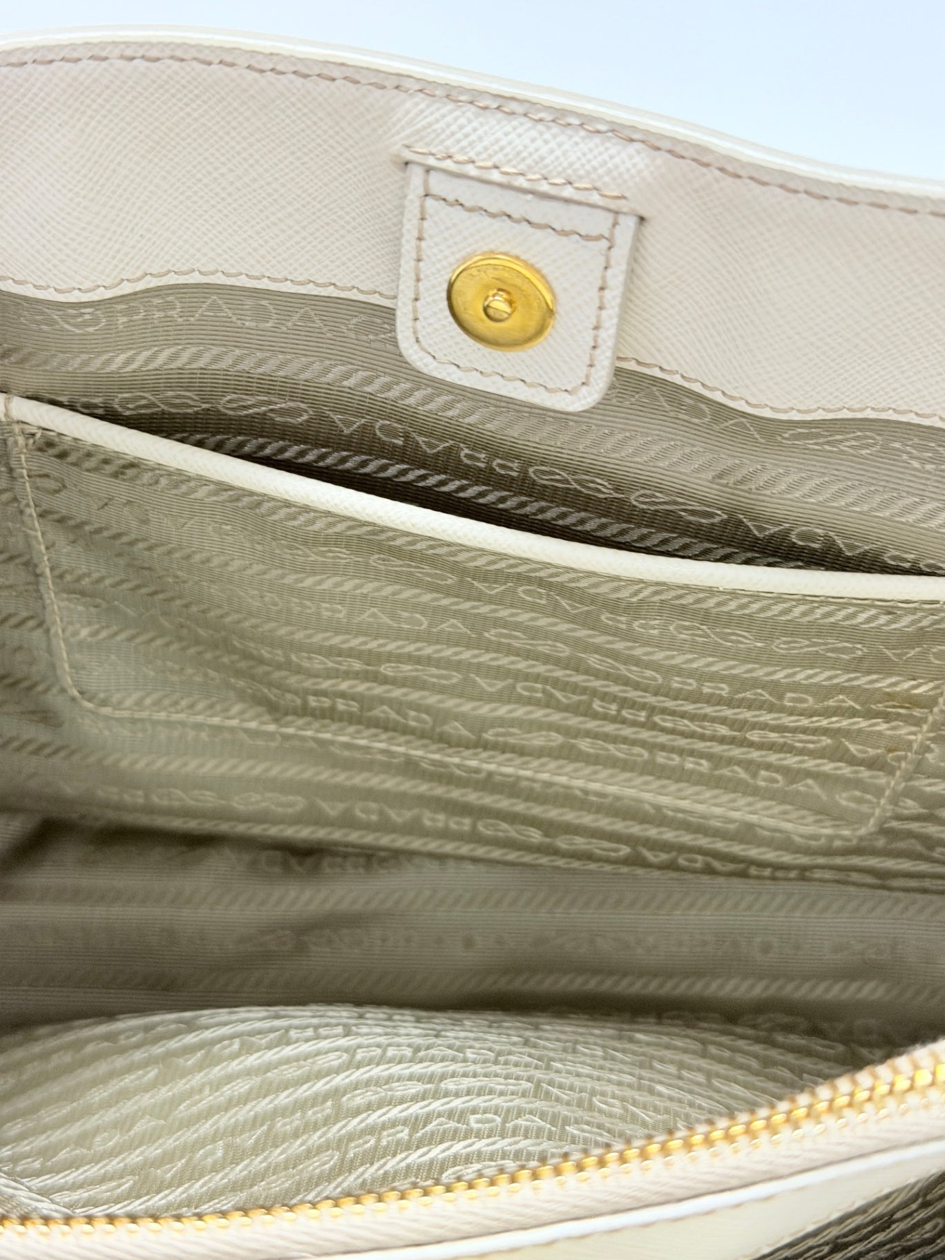 Lynn's Closet Boutique Prada Galleria handbag interior featuring beige branded lining, slip pocket, and gold snap closure.