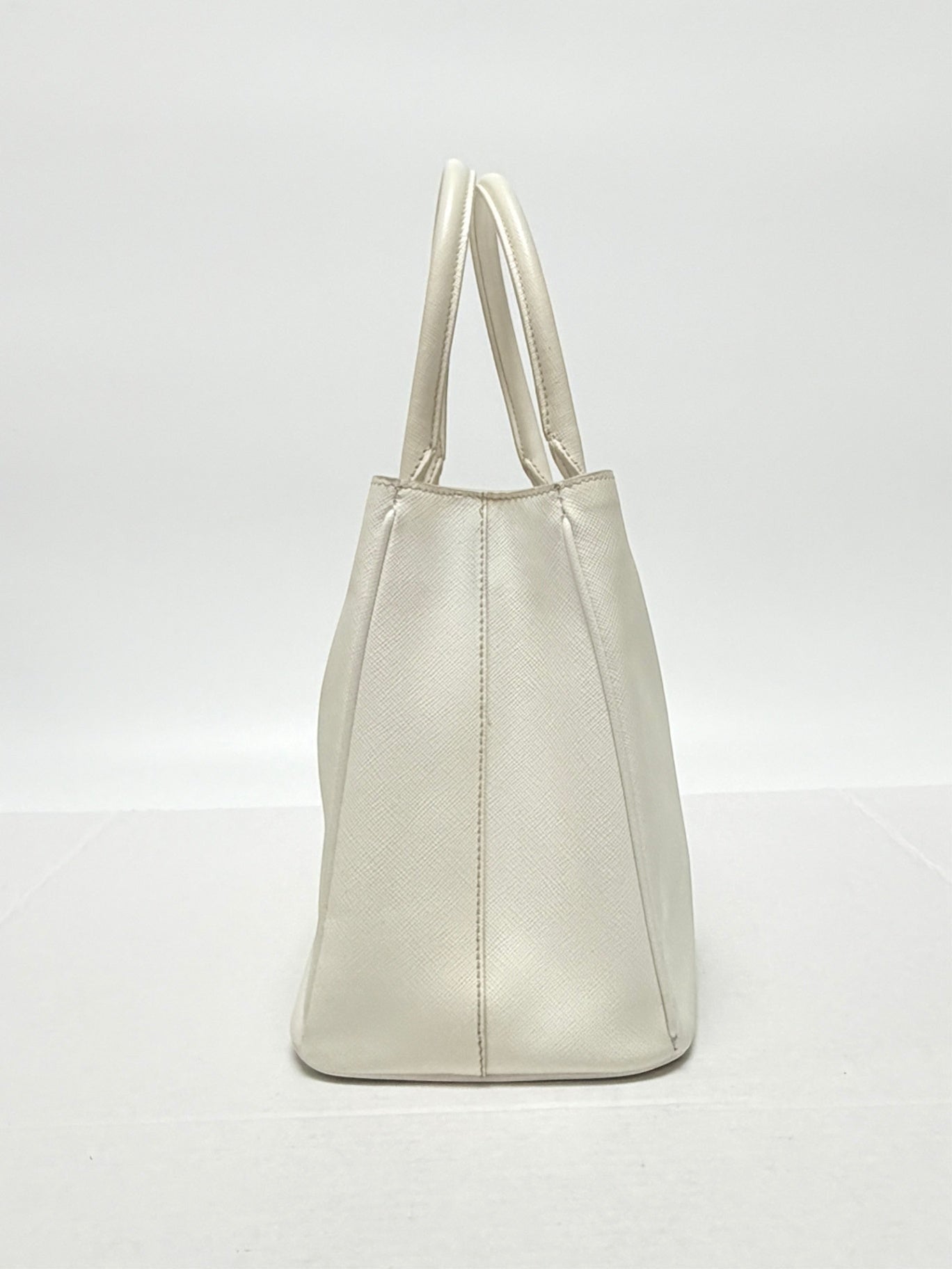 Lynn's Closet Boutique white Prada Galleria Saffiano leather handbag, side profile view showing structured design.