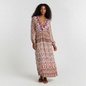 Model wearing a Lynn's Closet Boutique Anthropologie Raga bohemian maxi dress with earthy print and purple embroidery.