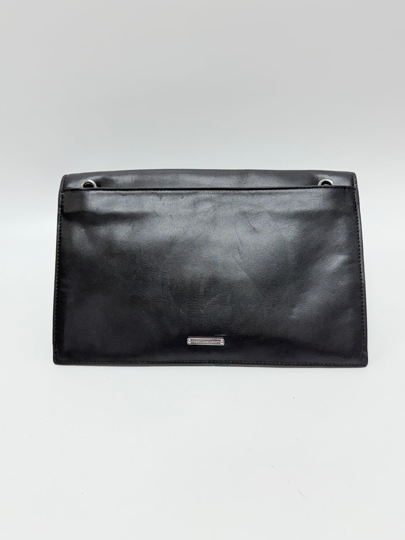 Lynn's Closet Boutique Rebecca Minkoff Sofia black leather clutch bag with silver hardware, back view.