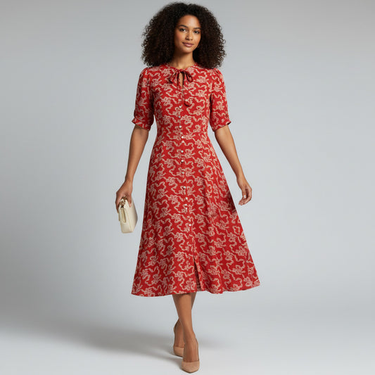 Lynn's Closet Boutique red midi dress with all-over white bow print, short sleeves, and tie-neck detail. Size 8.