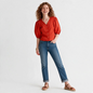 Lynn's Closet Boutique model wearing a red Tory Burch cotton poplin puff sleeve cropped top with blue jeans.