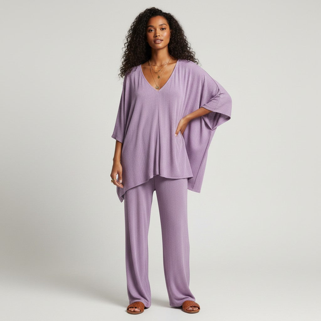 Model wearing a lilac Ripley Rader 2-piece pant set with a V-neck dolman top from Lynn's Closet Boutique.