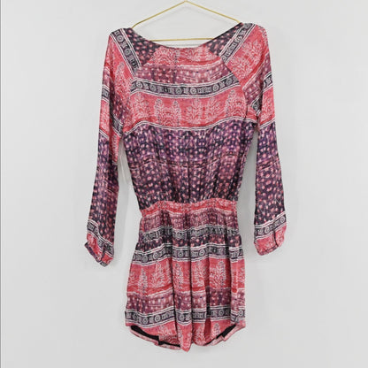 Lynn's Closet Boutique Rory Beca long sleeve bohemian dress in pink, red, and purple with a tie-neck and elastic waist.
