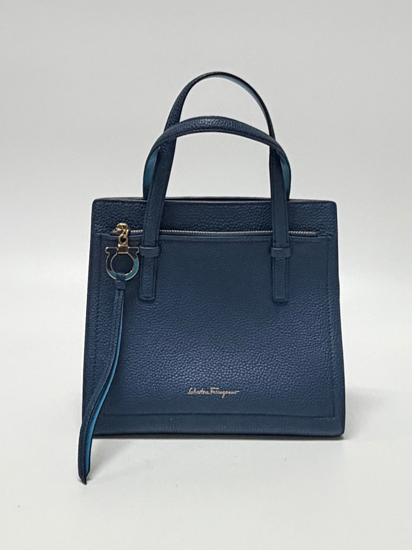 Lynn's Closet Boutique Salvatore Ferragamo Amy small blue pebbled leather tote bag with gold Gancini charm.