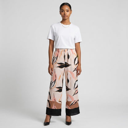 Lynn's Closet Boutique satin wide-leg pants with abstract leaf print in blush, tan, and black with a color-blocked hem.