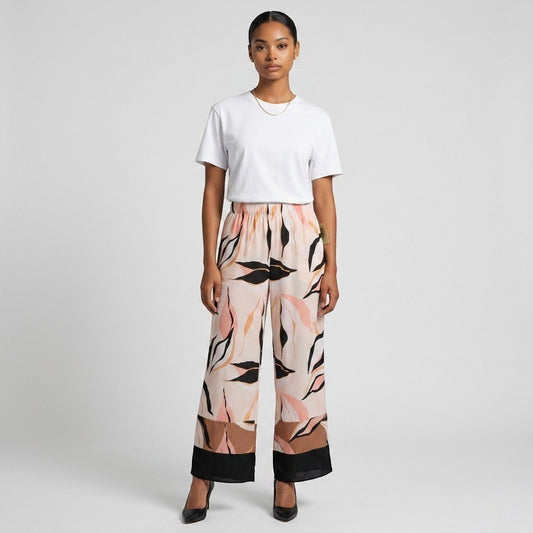 Lynn's Closet Boutique satin wide-leg pants with abstract leaf print in blush, tan, and black with a color-blocked hem.
