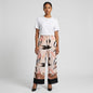 Lynn's Closet Boutique satin wide-leg pants with abstract leaf print in blush, tan, and black with a color-blocked hem.