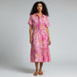 Model wearing Lynn's Closet Boutique Sheridan French bubblegum pink zebra print midi dress with short sleeves.