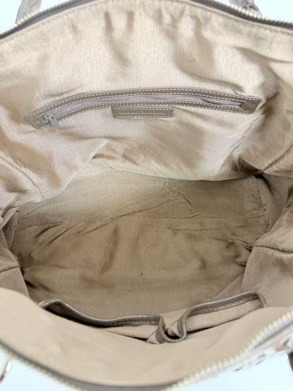 Interior view of a Lynn's Closet Boutique Sondra Roberts woven patent brown bag with beige fabric lining and pockets
