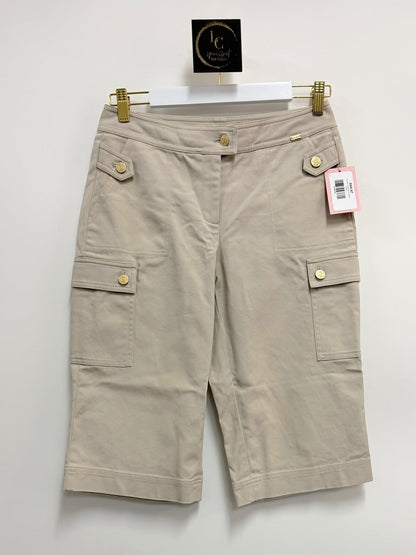 Lynn's Closet Boutique St. John khaki cotton blend cargo shorts with gold-tone button details hanging on a white hanger