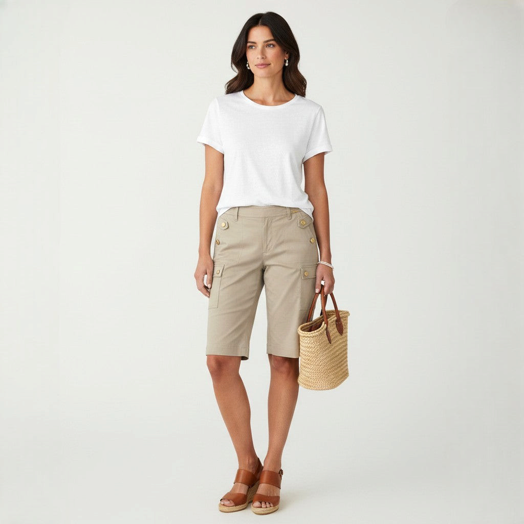 Model wearing Lynn's Closet Boutique St. John khaki cargo shorts with gold button details and a white t-shirt