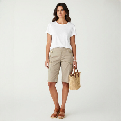 Model wearing Lynn's Closet Boutique St. John khaki cargo shorts with gold button details and a white t-shirt